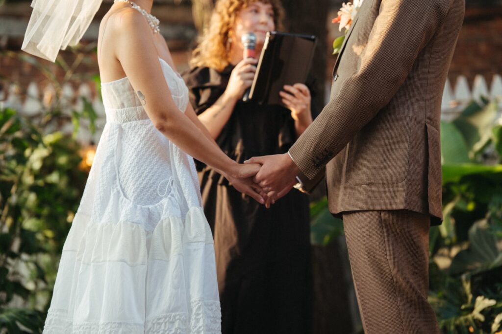 The bride and groom holding hands during a wedding day at Roberta's Pizza in Williamsburg, Brooklyn NYC. 